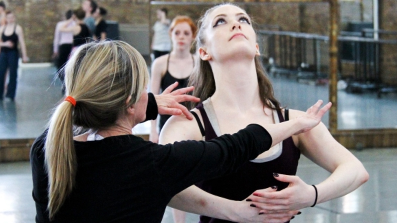 An instructor teaching a student in a dance studio at the University of Iowa.