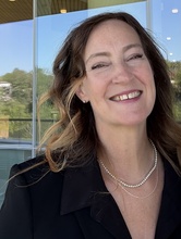 jennifer Kayle, smiling on the terrace of Hancher Auditorium