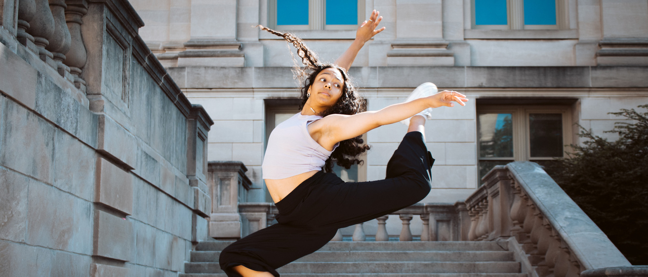 Undergraduate dance student dancing on the steps of the Old Capitol
