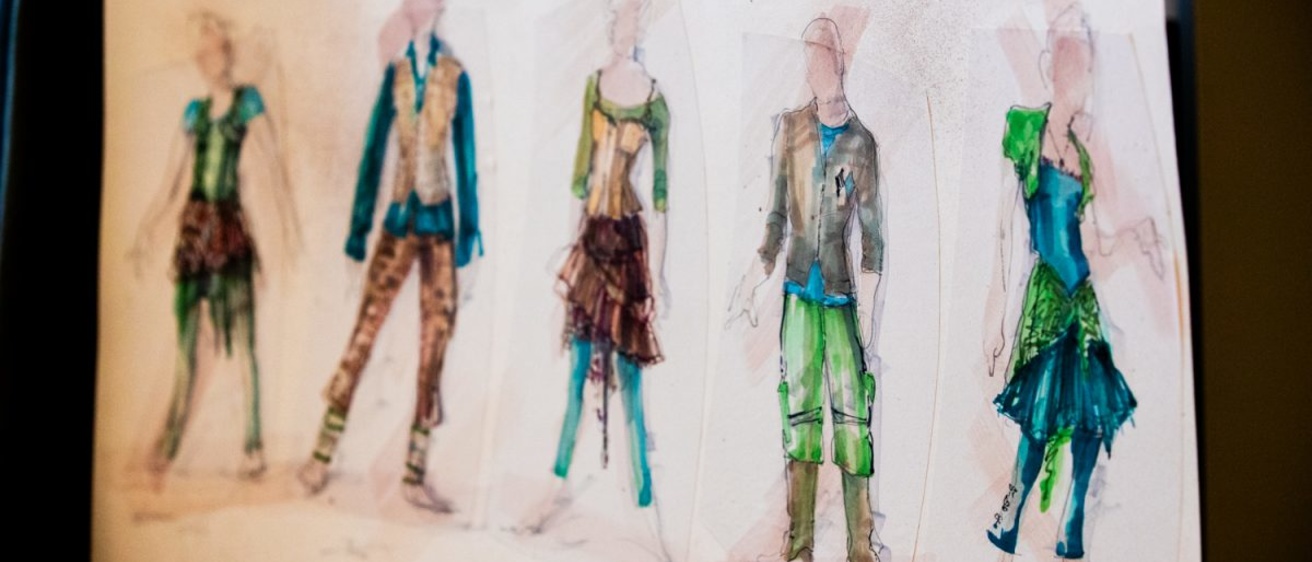 costume sketches seen hanging in costume shop