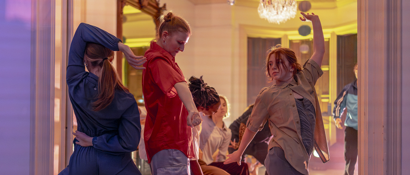 students dancing in a house-party setting in a recent thesis performance at Public Space One