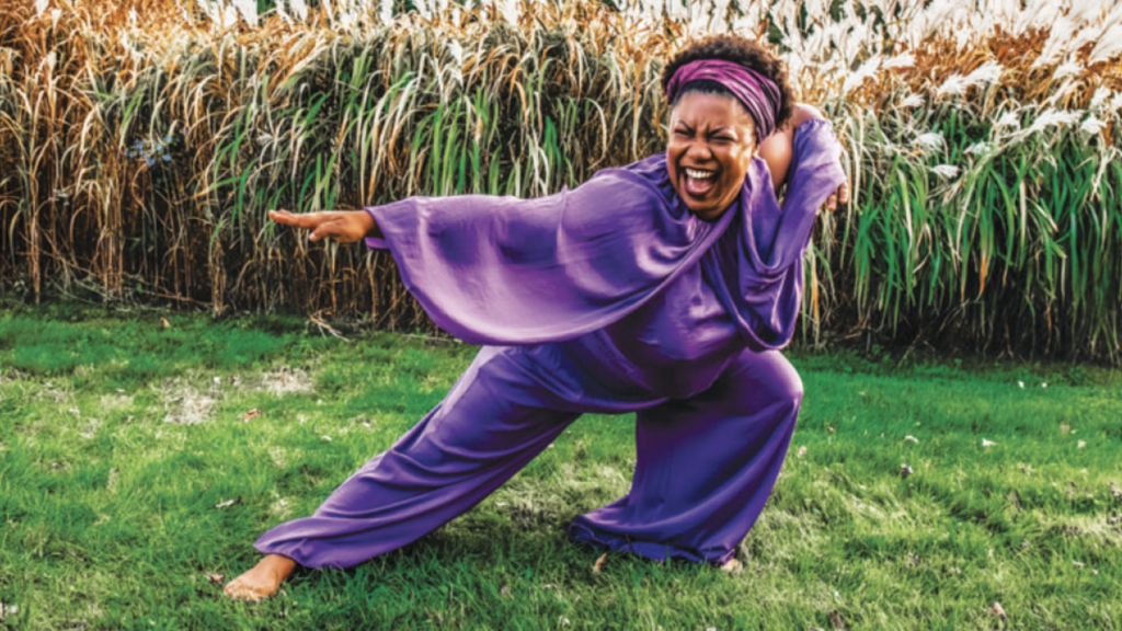 Sydnie L. Mosley, dancing in a field with green grass under her feet